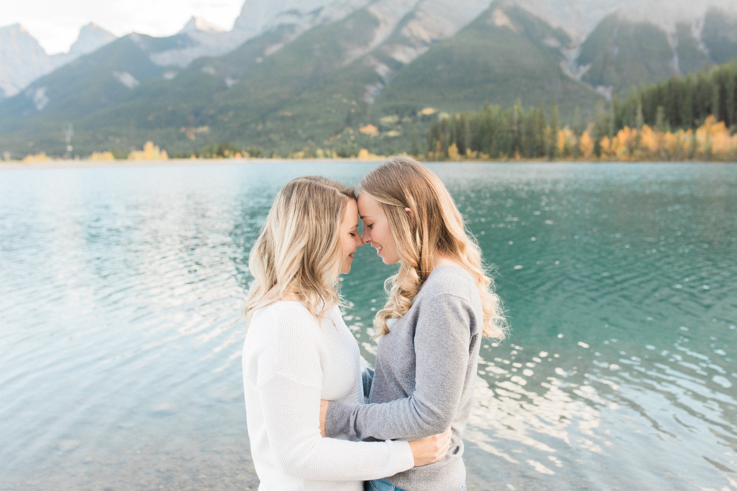Jayden Campbell Canmore LGBTQ Engagement Session at Quarry Lake. Couple touching foreheads and smiling.
