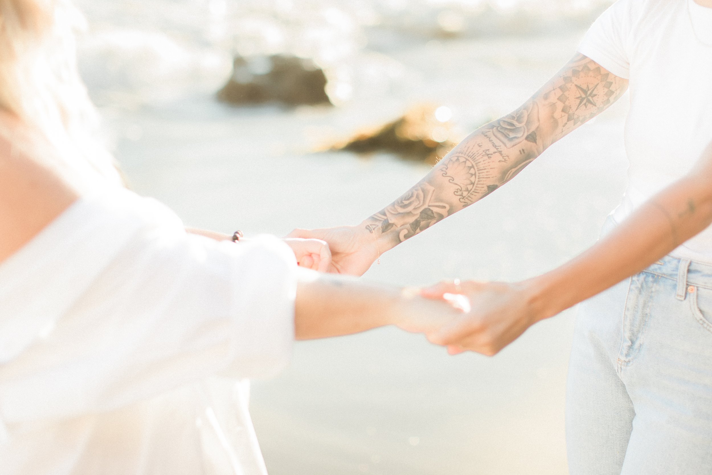 Jayden Campbell LGBTQ Maternity Photographer Two women holding hands tattooed golden hour